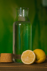 Glass with water and lemon on green background. The concept of a healthy lifestyle, weight loss.