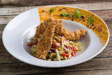 tasty crispy chicken salad appetizer in white plate