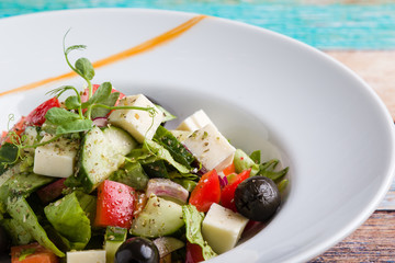 fresh tasty greek salad appetizer on white plate