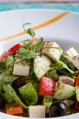 fresh tasty greek salad appetizer on white plate