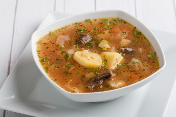 fresh tasty traditional stew soup in white bowl
