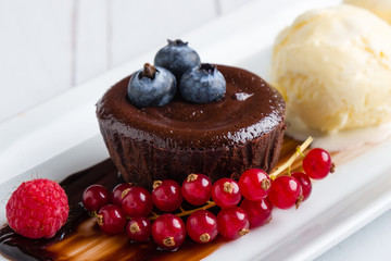 lava cake with ice cream and fruits on white plate