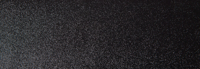 Silver sequins pattern. Sparkling sequins on black wool fabric as background