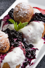 fresh delicious cottage cheese donuts with jam on white plate