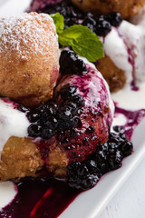 fresh delicious cottage cheese donuts with jam on white plate