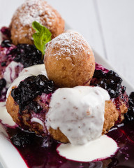 fresh delicious cottage cheese donuts with jam on white plate