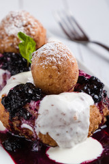 fresh delicious cottage cheese donuts with jam on white plate