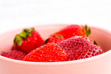 Sweet, juicy, ripe strawberries. Red, large strawberries in a pink cup. Food with vitamins. Vegetarian food.