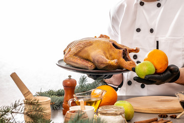 duck with oranges and apples by cook hands, cooking ingredients on kitchen table white background. copy text