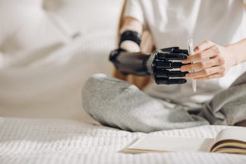 girl performing catching activities with a prosthetic limb, diasbled girl is going to write