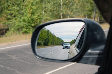 look in the rear view mirror of a car