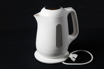 white kettle on black background