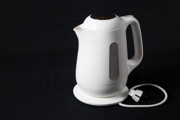 white kettle on black background
