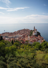 Panoramic view of old town of Piran/Pirano from medieval walls, on a sunny and blue day