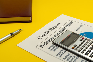 Credit report on the yellow table and a pen