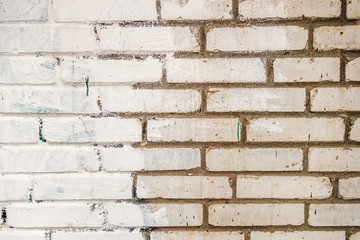 wall of white brick partially painted with white paint