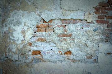 red brick wall with old falling plaster. Background.
