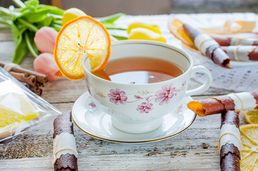 cup of tea with lemon and sweets