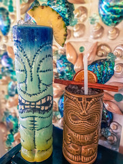 Naklejka premium Fresh tropical cocktails served in ceramic Tiki style glasses