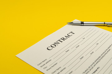 The contract for the yellow table and pen.