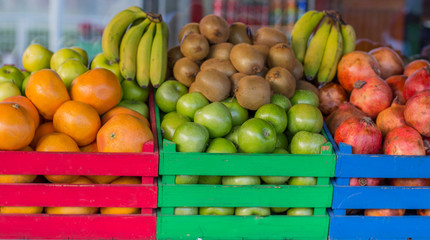 fruits in colored wooden crates