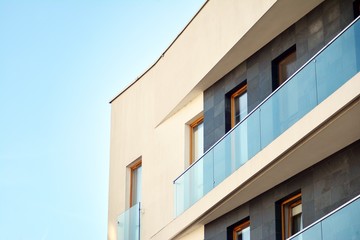 Obraz premium Modern apartment buildings on a sunny day with a blue sky. Facade of a modern apartment building