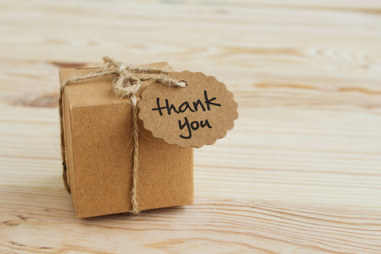 Gift Box With An Inscription Thank You On A Light Wooden Background. Copy Space.