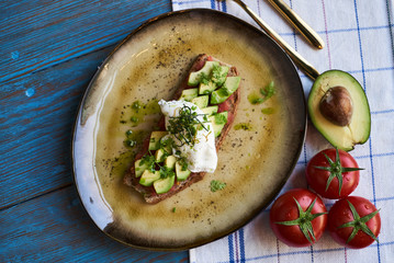 Avocado Toast and Poached Egg with Baked Tomatoes, close-up