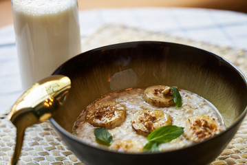 Healthy breakfast concept with oatmeal bowl and milk glass