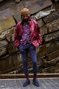 Adult stands in front of rock wall