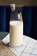 Bottle of milk on wooden background, close-up. Healthy breakfast concept