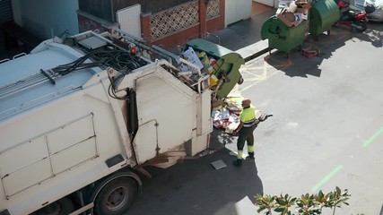 Garbage truck is loading waste automatically, shifting dumpster