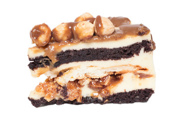 piece of cake with caramel and hazelnut at white background