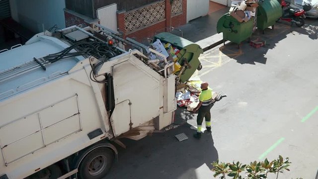 Garbage truck is loading waste automatically, shifting dumpster