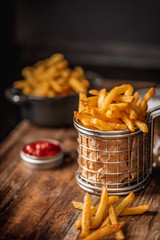 French fries in a basket with ketchup - 249758419