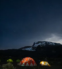 Papier Peint photo Kilimandjaro Lighted tents in the night in front of Mount Kilimanjaro