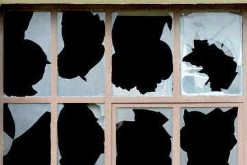 Old window with broken panes of glass
