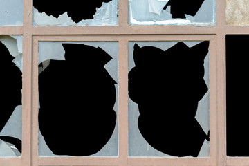 Old window with broken panes of glass