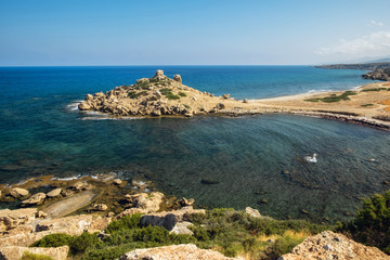 Small Alagadi beach panorama with peninsula and dry pasture