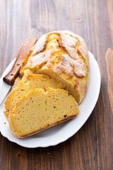 corn bread with knife on white dish