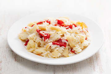 rice with cod fish and red pepper on white plate