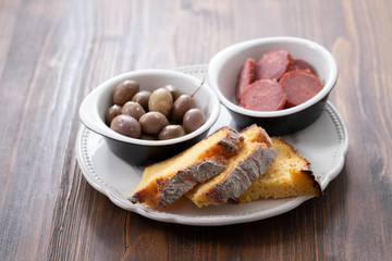 olives with smoked sausages and corn bread