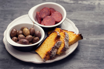 olives with smoked sausages and corn bread