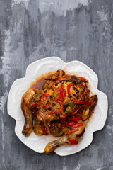 roasted chicken with herbs and vegetables on white dish