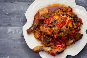 roasted chicken with herbs and vegetables on white dish