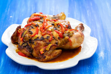roasted chicken with herbs and vegetables on white dish