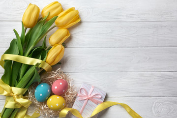 Happy Easter. Congratulatory easter background. Easter eggs and flowers.