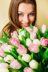 Beautiful young woman enjoying the spring, holding pink flowers. natural beauty. skin care. spring bride bouquet. happy women's day.