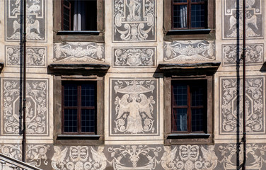 Sgraffito wall decor at front of historical building with fairies and angels