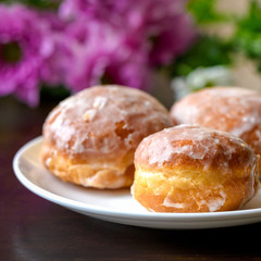Homemade donuts on white plate with flowers